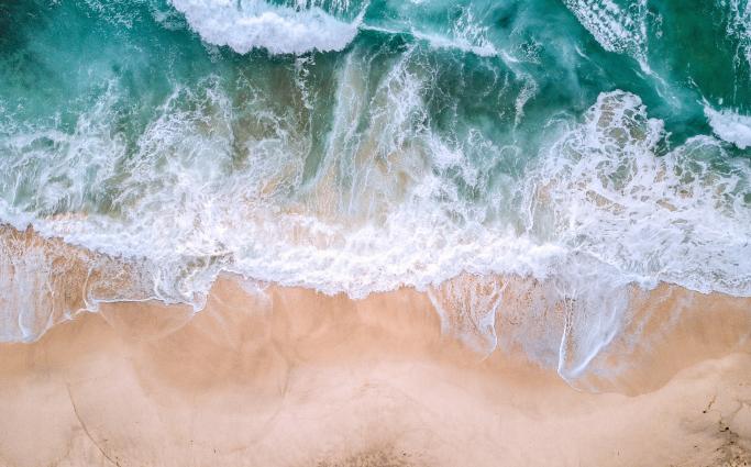 Waves crashing on sandy shore