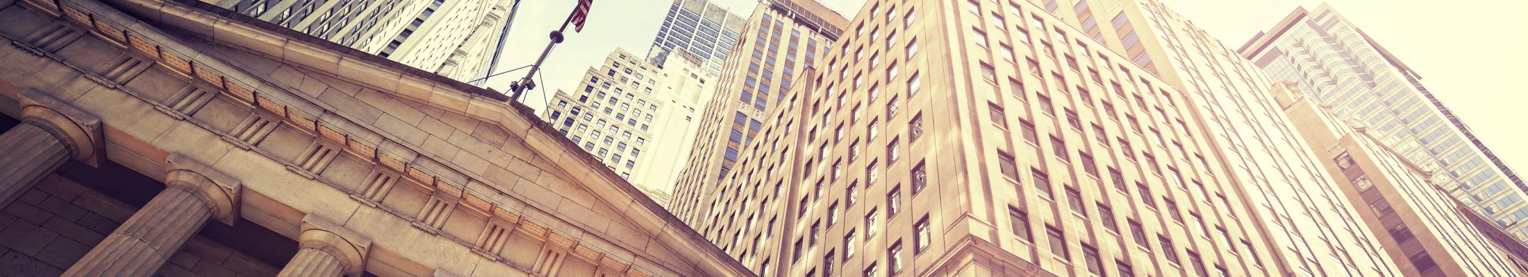 Tall Buildings with American Flag and Blue Sky