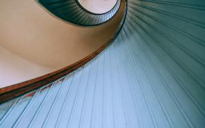 Looking down a blue spiral staircase