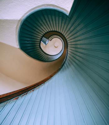 Looking down a blue spiral staircase